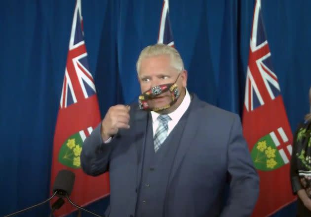 Ontario Premier Doug Ford takes off his face mask during a press conference at Queen's Park in Toronto on Sept. 29, 2020.