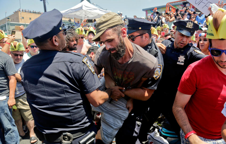 <p>Police remove an animal rights activist as they try to protest at the Nathan’s Annual Famous International Hot Dog Eating Contest won by Joey Chestnut, Tuesday July 4, 2017, in New York. (AP Photo/Bebeto Matthews) </p>