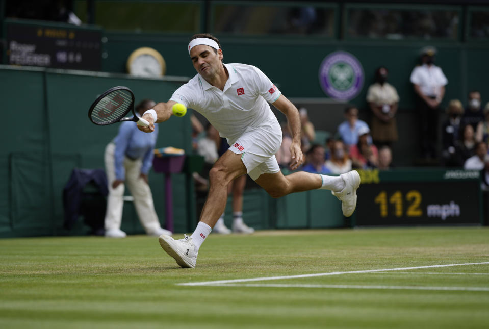 Switzerland's Roger Federer plays a return to Britain's Cameron Norrie during the men's singles third round match on day six of the Wimbledon Tennis Championships in London, Saturday July 3, 2021. (AP Photo/Alastair Grant)