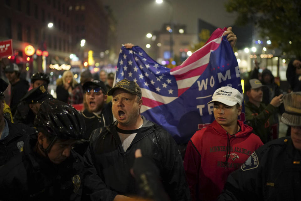 Pro-Trump people yell at protesters after the President's rally. (Photo: AP) 