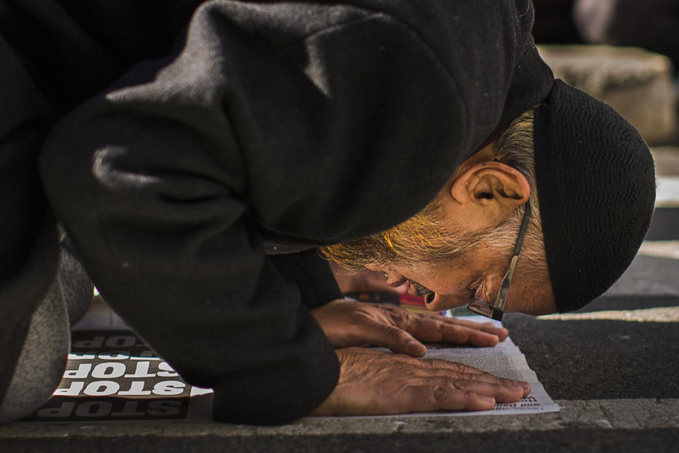 FILE - In this Sunday, Feb. 19, 2017 file photo, a man prays during a rally in New York's Times Square against President Donald Trump's executive order banning travel from several Muslim-majority nations. (AP Photo/Andres Kudacki)