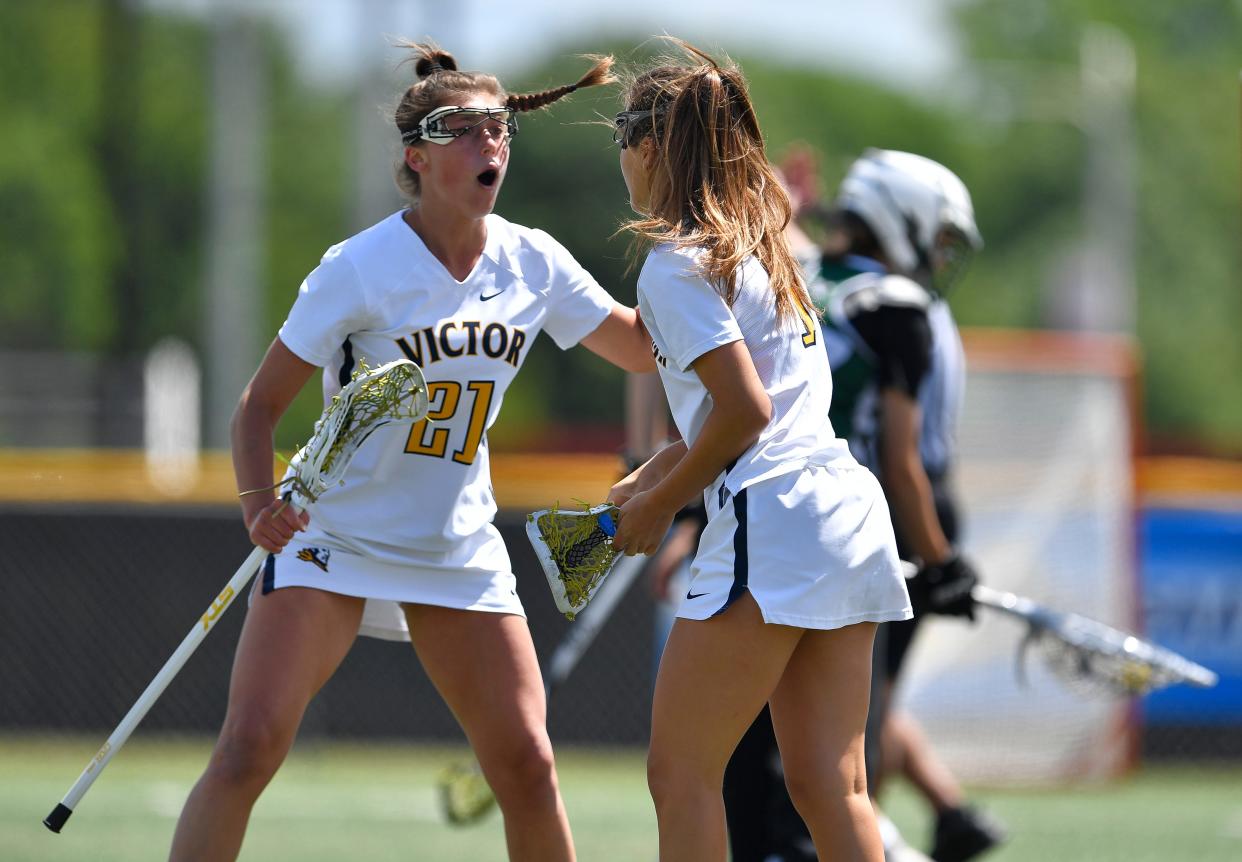 Victor's Olivia Bruno, left, celebrates with Eva Pronti after scoring against Fayetteville-Manlius during a Class B semifinal at the NYSPHSAA Girls Lacrosse Championships in Cortland, N.Y., Friday, June 10, 2022.