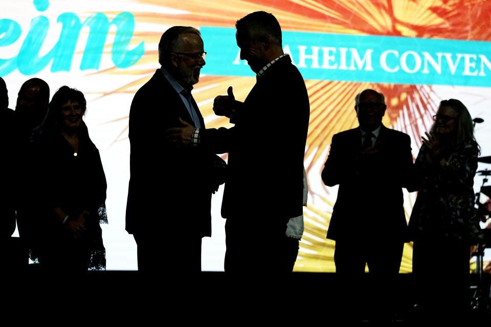 Incoming Southern Baptist Convention President Ed Litton, center left, talks with outgoing President J. D. Greear, center right, at the conclusion of the annual Southern Baptist Convention meeting, Wednesday, June 16, 2021, in Nashville, Tenn. (AP Photo/Mark Humphrey)