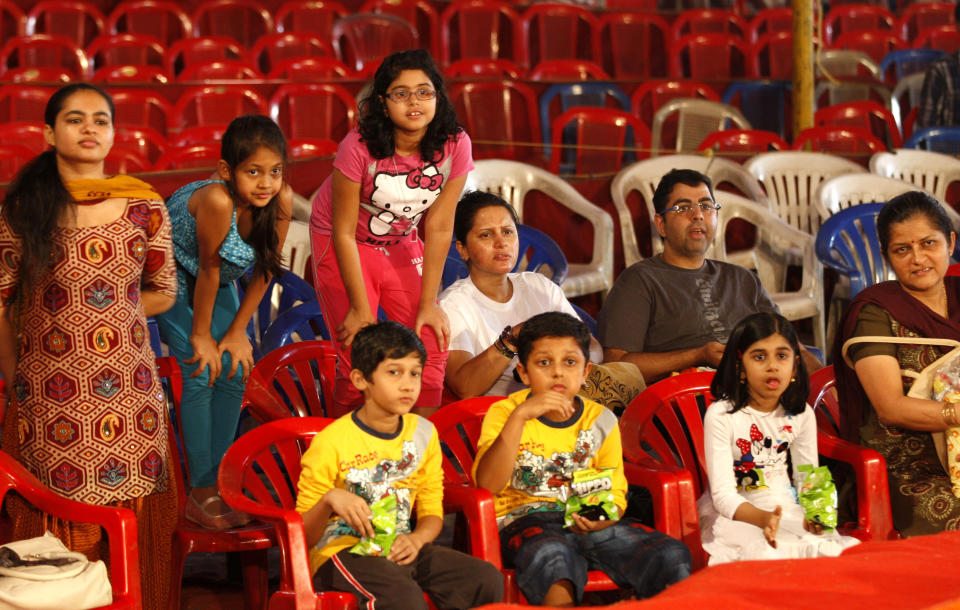 In this April 11, 2013 photo, Indian spectators watch a performance at the Rambo Circus on the outskirts of Mumbai, India. Circuses around the world may struggle to compete with an ever-increasing array of entertainment options, but India’s once-widespread industry in particular has gone through cataclysmic changes. In the 1990s, there were 300 circuses operating throughout the country. That number has now dwindled to about 30, says circus manager John Matthew, and many of those are in financial trouble due to rising costs of renting field space, shrinking revenues and - crucially - two Supreme Court rulings that took away two of the industry’s main attractions. (AP Photo/Rafiq Maqbool)