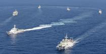 Vessels from the China Maritime Surveillance and the Japan Coast Guard are seen near disputed islands, called Senkaku in Japan and Diaoyu in China, in the East China Sea, in this photo taken by Kyodo September 10, 2013. China said it would not tolerate provocation after Japan's top government spokesman said on Tuesday Japan might station government workers on disputed islands in the East China Sea to defend its sovereignty. Mandatory Credit. (REUTERS/Kyodo)