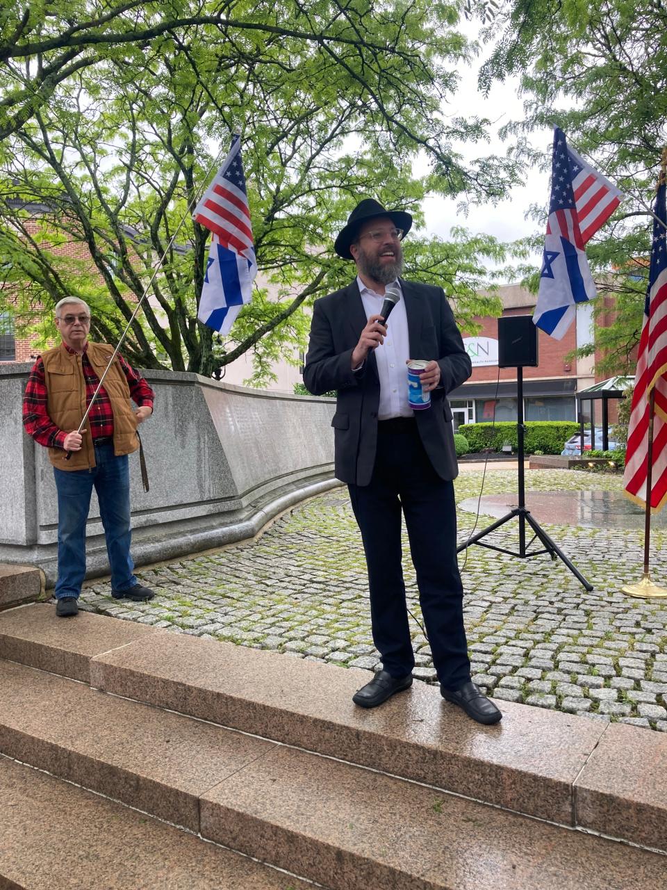 Rabbi Mendel Prus, director of Chabad of Doylestown, addresses the rally for Israel on a rainy Sunday afternoon, May 12, 2024 in Doylestown Borough, Pa.