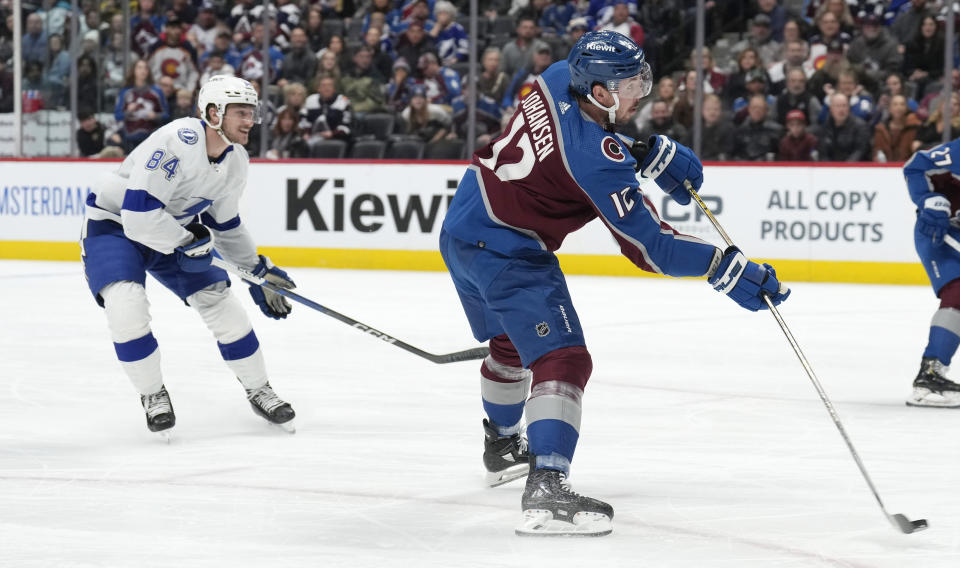 Colorado Avalanche center Ryan Johansen, right, shoots a goal as Tampa Bay Lightning left wing Tanner Jeannot, left, pursues in the first period of an NHL hockey game Monday, Nov. 27, 2023, in Denver. (AP Photo/David Zalubowski)