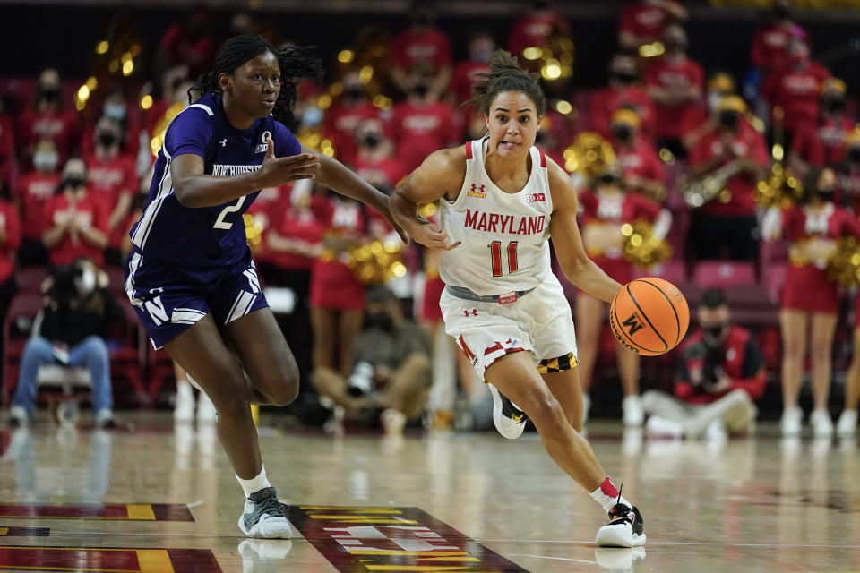 Maryland guard Katie Benzan (11) drives against Northwestern guard Lauryn Satterwhite (2) during the second half of an NCAA college basketball game, Sunday, Jan. 23, 2022, in College Park, Md. Maryland won 87-59. (AP Photo/Julio Cortez)