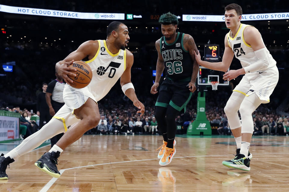 Utah Jazz's Walker Kessler (24) screens Boston Celtics' Marcus Smart (36) as Talen Horton-Tucker (0) drives for the basket during the first half of an NBA basketball game Friday, March 31, 2023, in Boston. (AP Photo/Michael Dwyer)