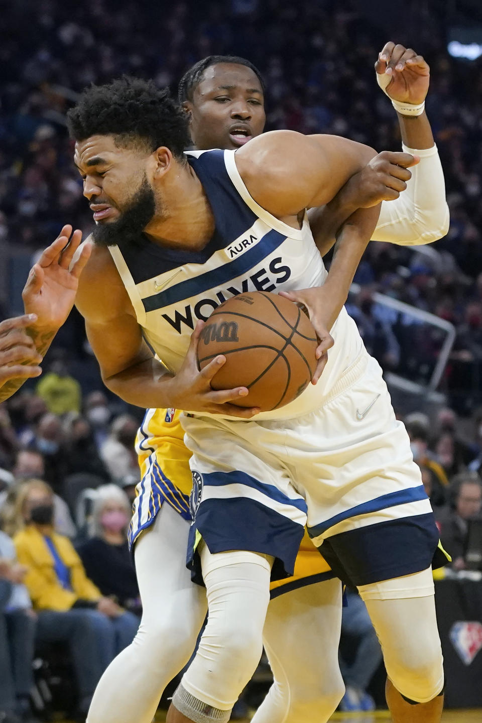 Minnesota Timberwolves center Karl-Anthony Towns, foreground, is defended by Golden State Warriors forward Jonathan Kuminga during the first half of an NBA basketball game in San Francisco, Thursday, Jan. 27, 2022. (AP Photo/Jeff Chiu)