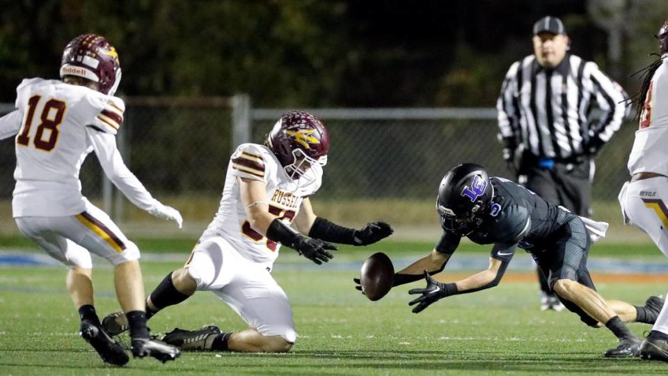 Lexington Catholic’s Sam Clements (5) recovers a first-half fumble during the Knights’ Class 3A second-round playoff win against Russell at Lexington Catholic High School on Friday.