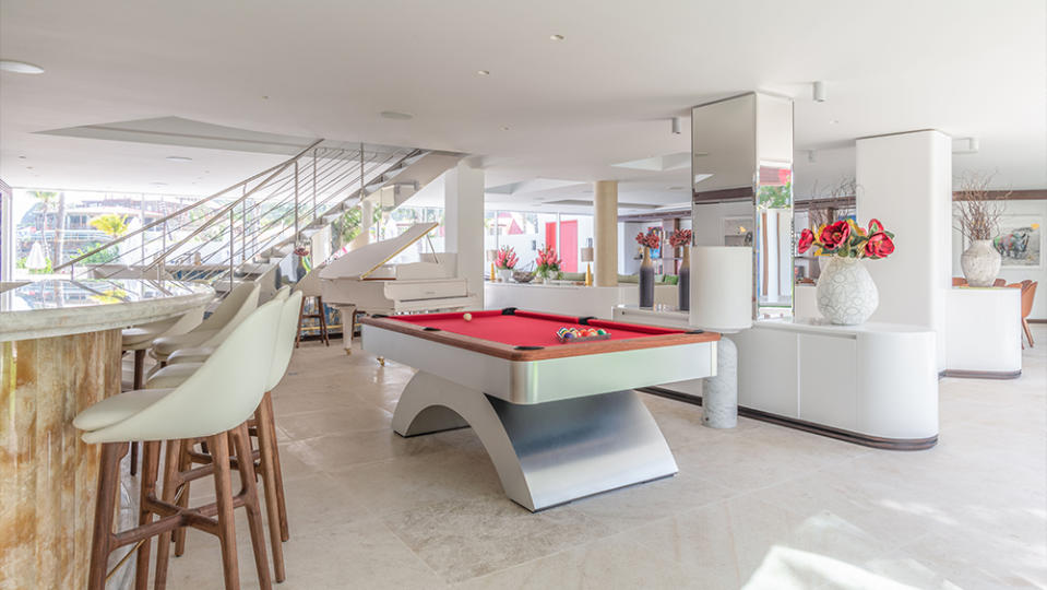 The living room and pool table – of course the baize is signature Eden Rock red.