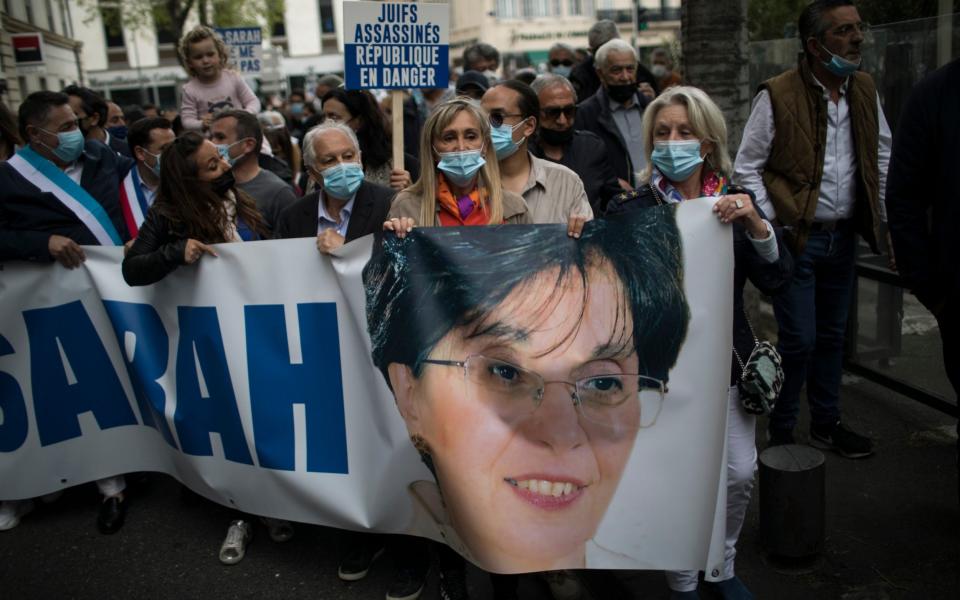 Protesters in Marseille hold a banner with Sarah's photo - AP Photo/Daniel Cole