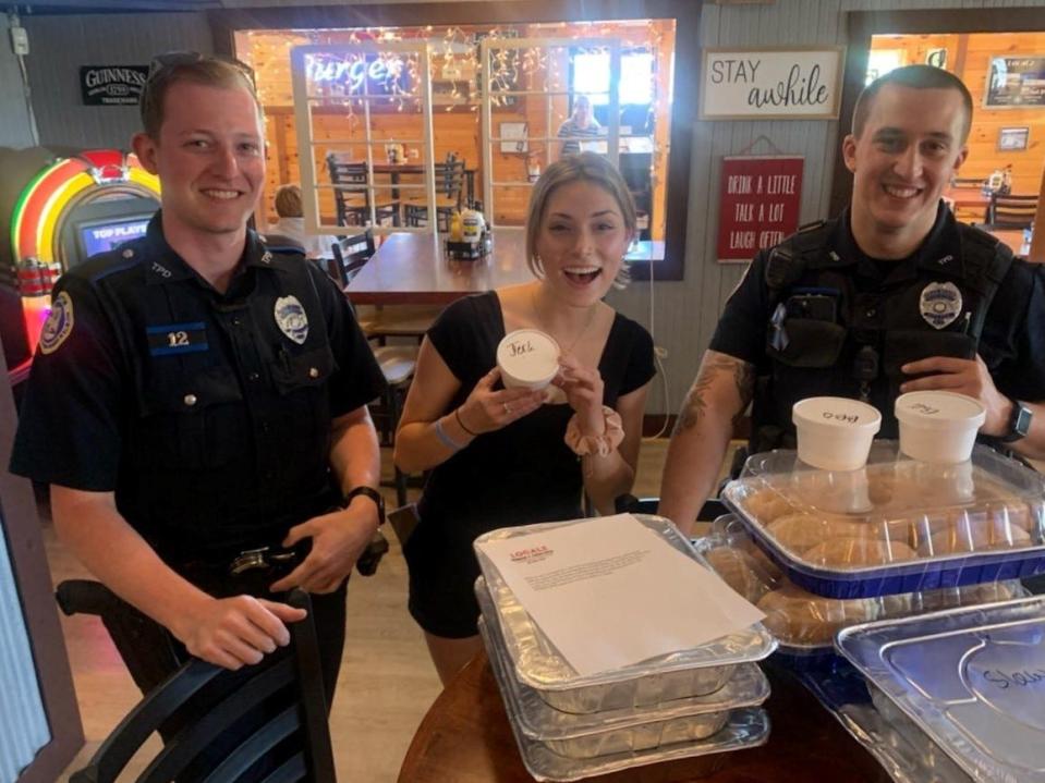 Tiverton police officers pick up food from Localz restaurant, given to the department in recognition of Police Week.