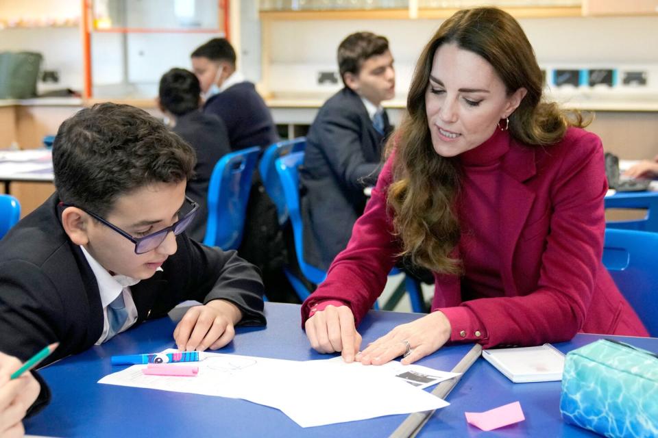 Catherine, Duchess of Cambridge interacts with students during a visit to Nower Hill High School