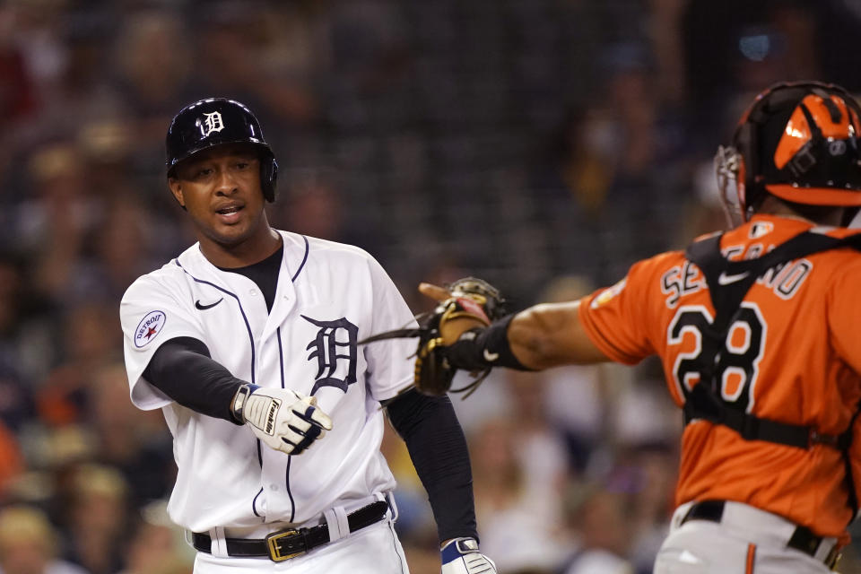 Detroit Tigers' Jonathan Schoop argues his strike call with umpire Ramon De Jesus as Baltimore Orioles catcher Pedro Severino walks off to celebrate the Orioles' 5-2 win after a baseball game, Saturday, July 31, 2021, in Detroit. (AP Photo/Carlos Osorio)