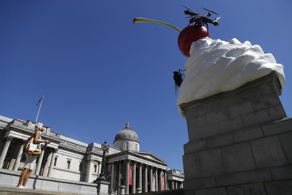 A new work of art entitled 'The End' by artist Heather Phillipson is seen after it was unveiled on the fourth plinth in Trafalgar Square in London, Thursday, July 30, 2020. Described as representing "exuberance and unease" and a "monument to hubris and impending collapse", The End, by British artist Heather Phillipson, will stay in place until spring 2022. (AP Photo/Alastair Grant)