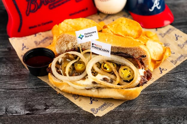 •	The Brushback:  Half a pound of tender beef brisket, smoked for 12 hours right in the outfield, topped with melted provolone cheese, caramelized sweet onions and savory mushrooms, spicy jalapenos, on a toasted hoagie with au jus on the side.  Served with Atlanta lemon pepper kettle chips. Available at The Carvery near section 111.