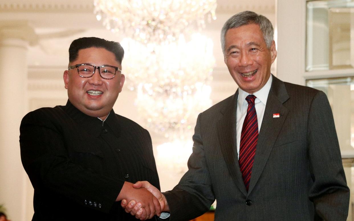 North Korea's leader Kim Jong-un shakes hands with Lee Hsien Loong, Singapore's prime minister  - REUTERS