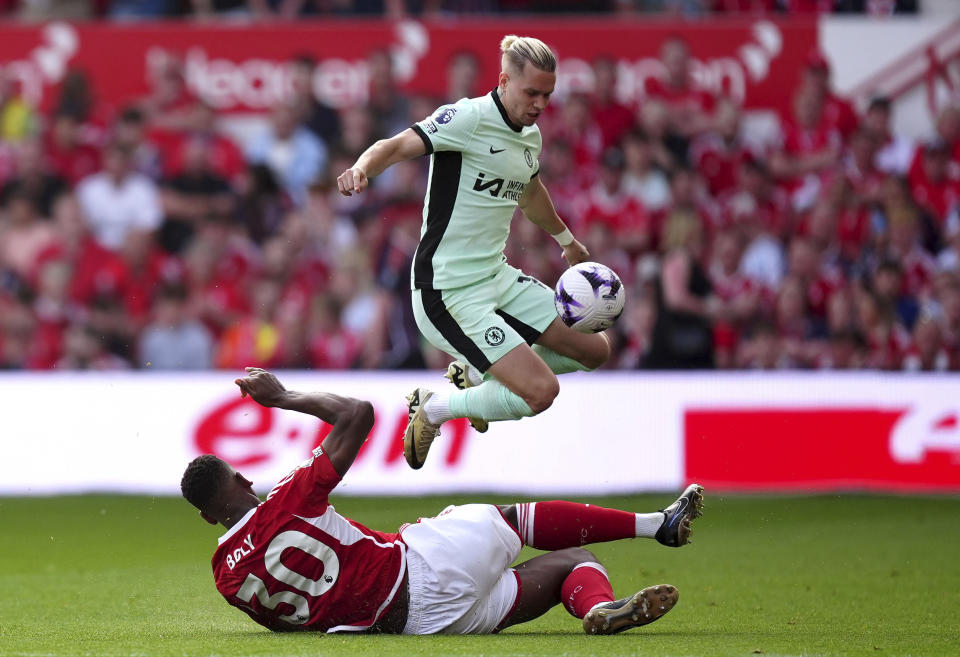 Nottingham Forest's Willy Boly, bottom, and Chelsea's Mykhaylo Mudryk, top, challenge for the ball during the English Premier League soccer match between Nottingham Forest and FC Chelsea in Nottingham, England, Saturday, May 11, 2024. (Mike Egerton/PA via AP)