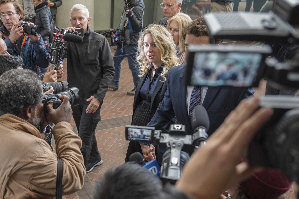 Theranos founder and CEO Elizabeth Holmes walks into federal court in San Jose, Calif., Friday, Nov. 18, 2022. A federal judge will decide whether Holmes should serve a lengthy prison sentence for duping investors and endangering patients while peddling a bogus blood-testing technology. (AP Photo/Nic Coury)