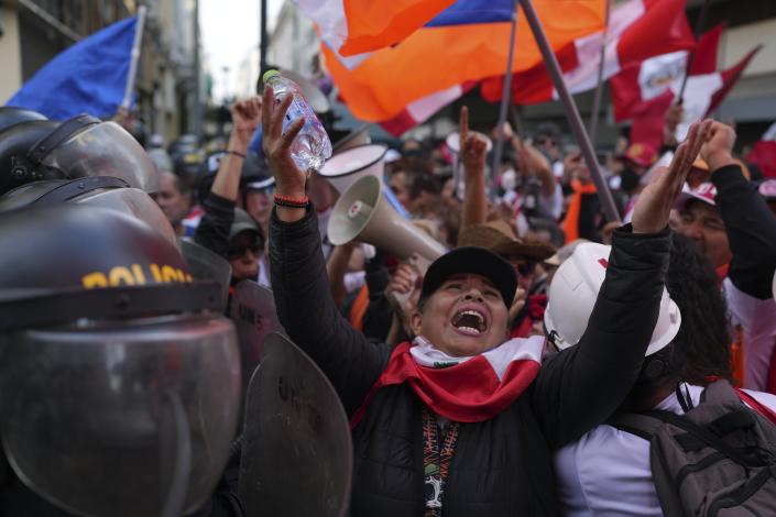Anti-government demonstrators protest near the government palace in Lima, Peru, Sunday, Nov. 20, 2022. (AP Photo/Guadalupe Pardo)