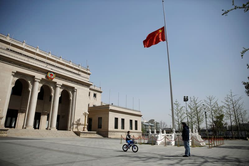 The Chinese national flag flies at half-mast at the CPPCC headquarters in Beijing