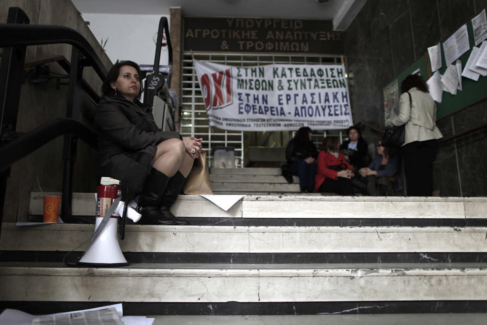 Agriculture ministry workers are seen at the entrance to the ministry headquarters in Athens, which was occupied by protesting employees.