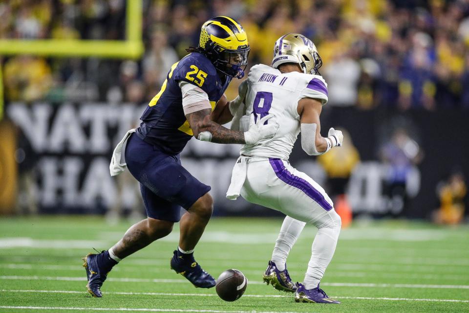 Michigan linebacker Junior Colson tackles Washington running back Will Nixon during the second half of the College Football Playoff national championship game in Houston, Jan. 8, 2024.