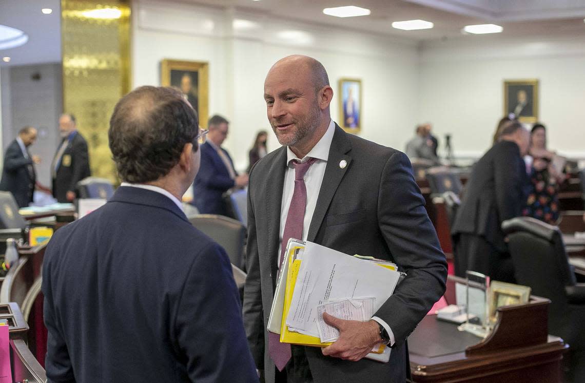 Senator Danny Britt, who represents Columbus and Robeson Counties talks with Senator Michael Lazzara, who represents Onslow and Jones Counties, following a vote on the state budget on Wednesday, November 17, 2021 in Raleigh, N.C.
