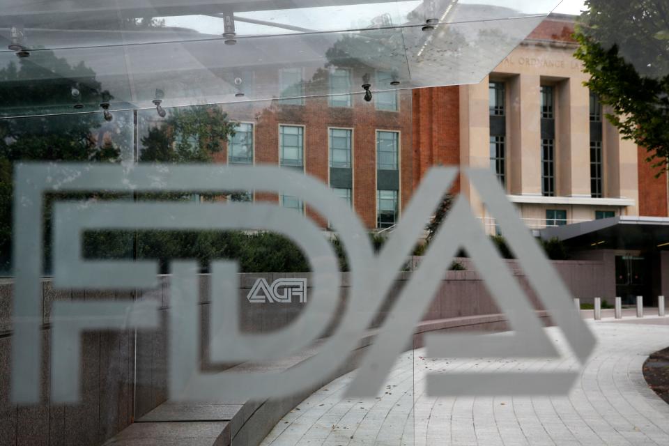 The U.S. Food and Drug Administration building behind FDA logos at a bus stop on the agency's campus in Silver Spring, Md.