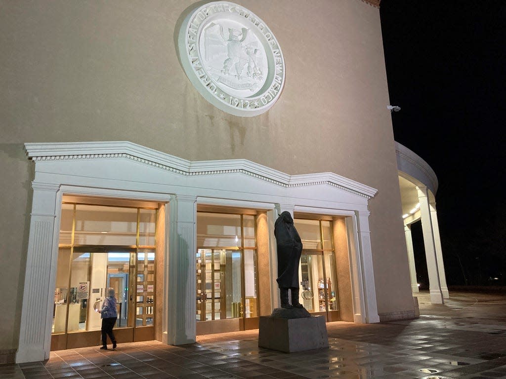 A visitor enters the New Mexico state Capitol building in Santa Fe, N.M., on Thursday, March 16, 2023, as legislators debated late into the evening.