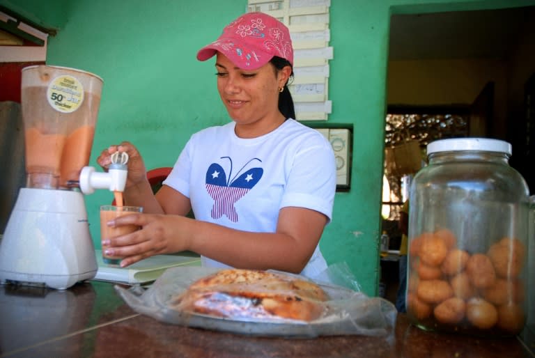 A woman works at a private coffee shop in the Cuban province of Holguin, on July 1, 2015