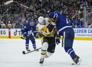 Pittsburgh Penguins forward Evgeni Malkin (71) gets pushed off the puck by Toronto Maple Leafs defenseman Jake Muzzin (8) during the third period of an NHL hockey game Thursday, Feb. 17, 2022, in Toronto. (Nathan Denette/The Canadian Press via AP)