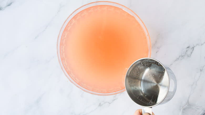 Adding soda to punch bowl