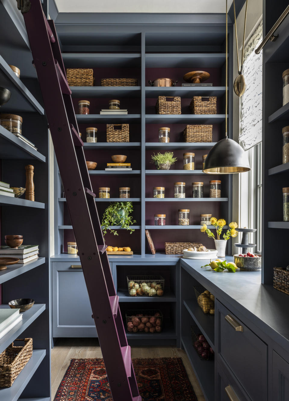 A kitchen pantry in deep tones of blue and purple