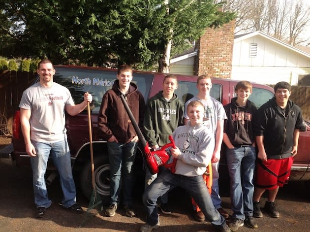 Members of the North Marion football team at work for gear — Facebook