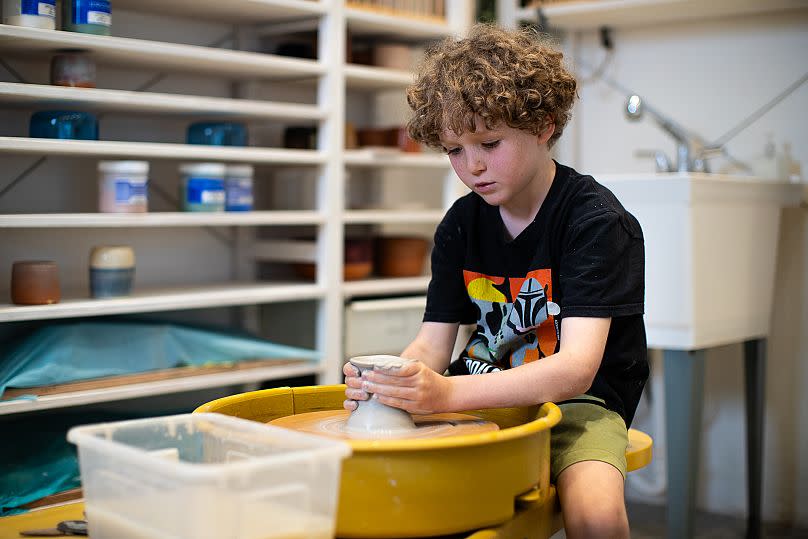 Oliver delights in the squishy nature of clay and loves the feeling of it on his fingers