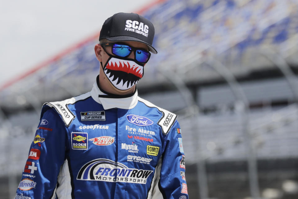 CORRECTS TO JOHN HUNTER NEMECHEK INSTEAD OF MICHAEL MCDOWELL - Driver John Hunter Nemechek walks to his car before the start of the NASCAR Cup Series auto race Sunday, May 17, 2020, in Darlington, S.C. (AP Photo/Brynn Anderson)