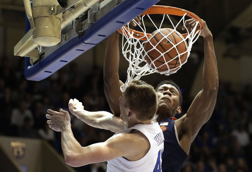 Virginia's De'Andre Hunter dunks against Duke's Jack White during the first half of an NCAA college basketball game in Durham, N.C., Saturday, Jan. 19, 2019. (AP Photo/Gerry Broome)