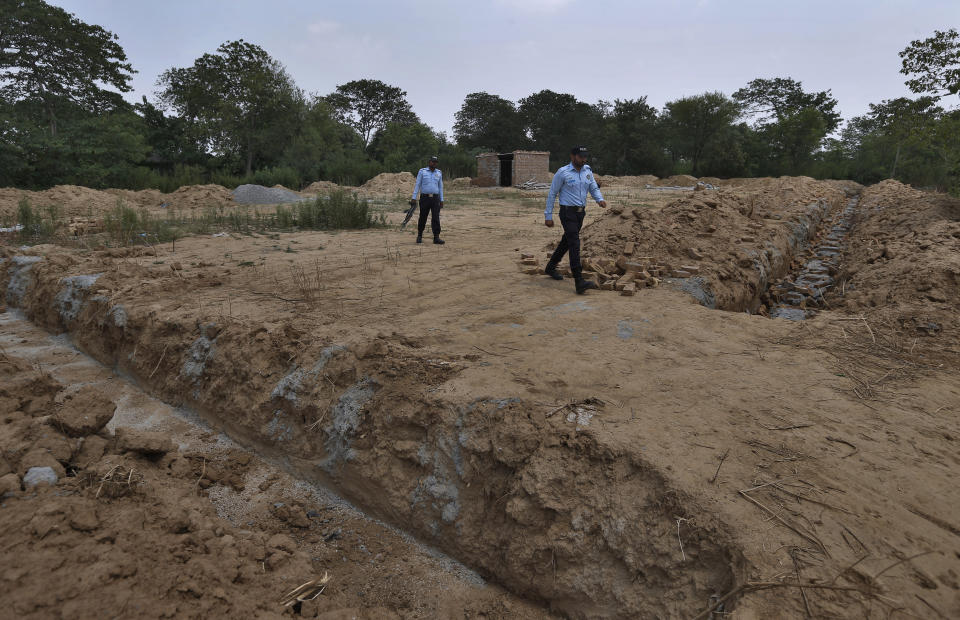 Police officers guard the site of a proposed Hindu temple after authorities stopped the construction, in Islamabad, Pakistan, Tuesday, July 7, 2020. Analysts and activists say minorities in Pakistan are increasingly vulnerable to Islamic extremists as Prime Minister Imran Khan vacillates between trying to forge a pluralistic nation and his conservative Islamic beliefs. (AP Photo/Anjum Naveed)