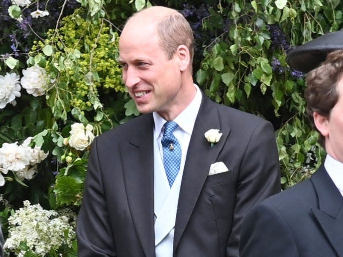 Prince William smiling at a wedding.