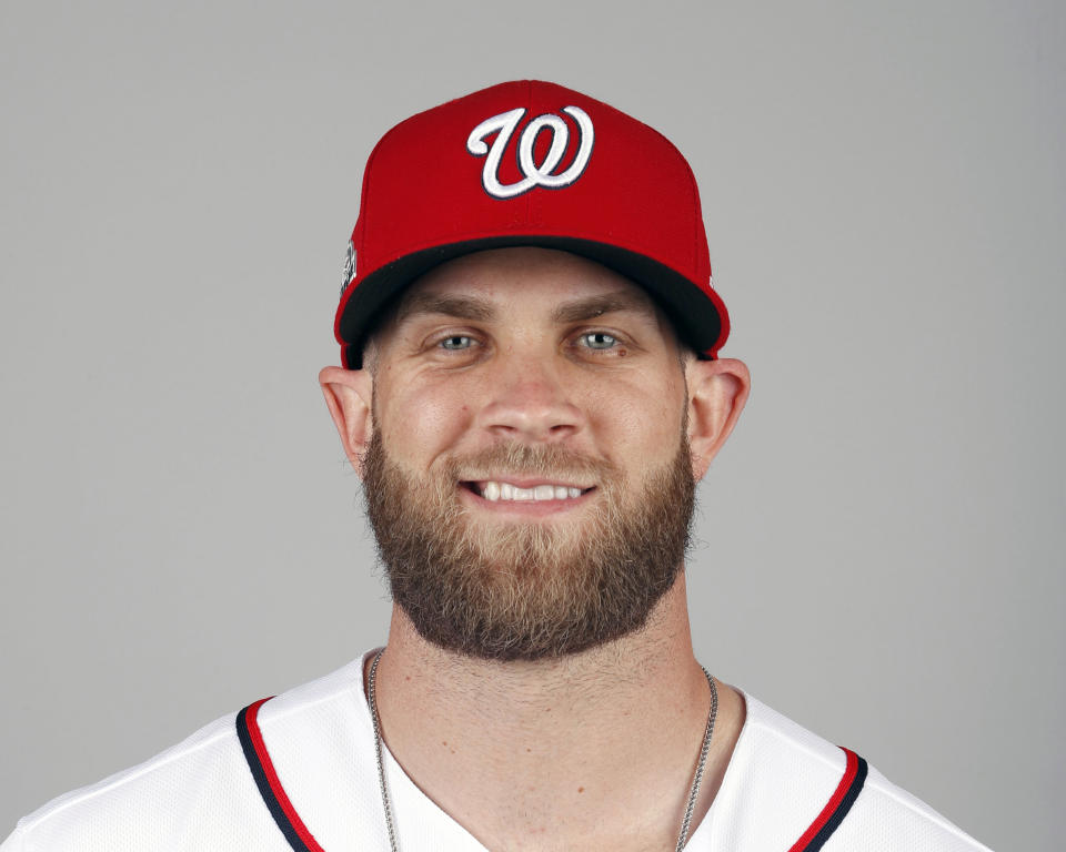 FILE - In this Feb. 22, 2018, file photo, Bryce Harper of the Washington Nationals baseball team poses in West Palm Beach, Fla. A person familiar with the negotiations tells The Associated Press that Bryce Harper and the Philadelphia Phillies have agreed to a $330 million, 13-year contract, the largest deal in baseball history. The person spoke to the AP on condition of anonymity Thursday, Feb. 28, 2019, because the agreement is subject to a successful physical. (AP Photo/Jeff Roberson, File)