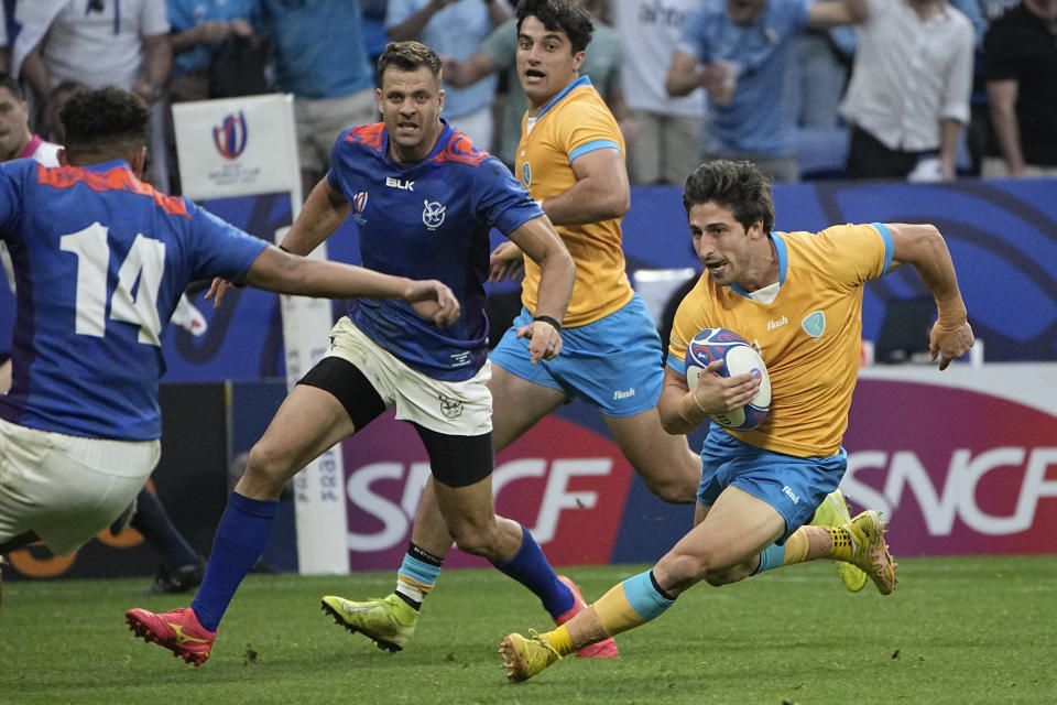 Uruguay's Santiago Arata on his way to score a try during the Rugby World Cup Pool A match between Uruguay and Namibia at the OL Stadium in Lyon, France, Wednesday, Sept. 27, 2023. (AP Photo/Laurent Cipriani)