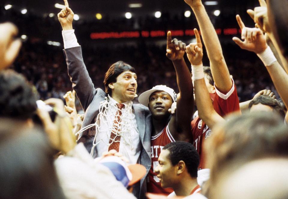 N.C. State head coach Jim Valvano celebrates with guard Dereck Whittenburg after his team's victory over Houston in the 1983 NCAA championship game.