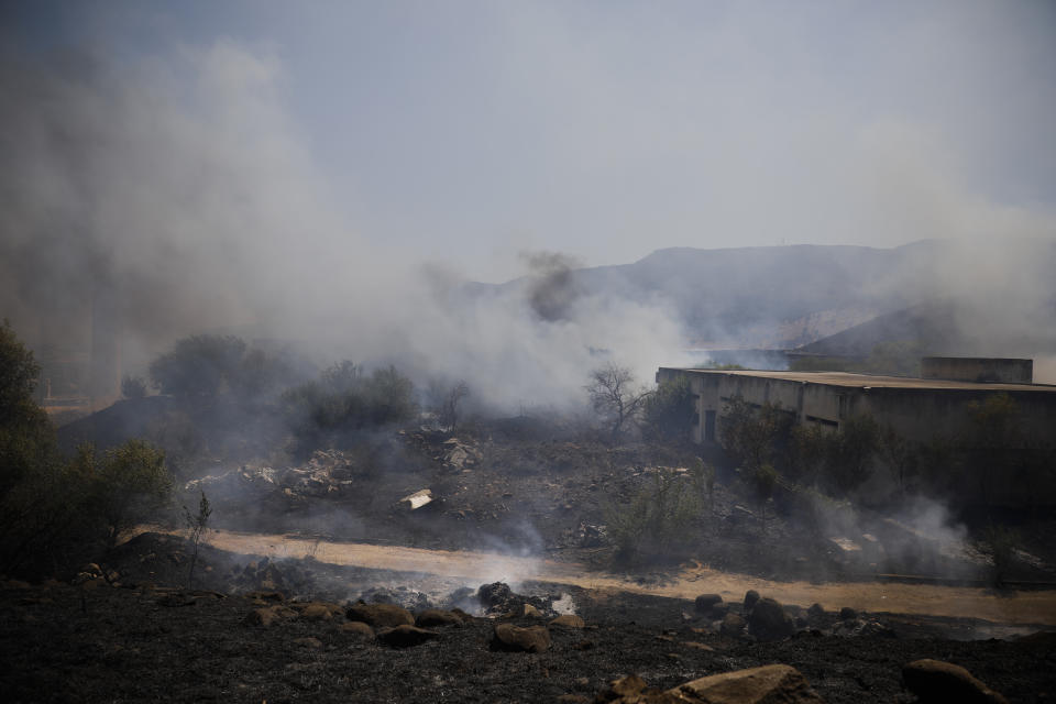 Fields burn following a hit by a rocket fired from Lebanon into Israeli territory, near the northern Israeli town of Kiryat Shmona, Wednesday, Aug. 4, 2021. Three rockets were fired from Lebanon into Israeli territory Wednesday and the army responded with sustained artillery fire, Israel's military said. There was no immediate information on damages or casualties. (AP Photo/Ariel Schalit)