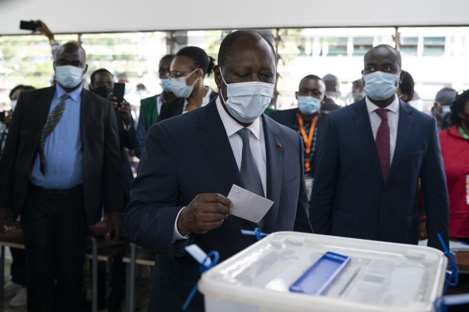 Ivory Coast President Alassane Ouattara casts his vote at a polling station during presidential elections in Abidjan, Ivory Coast, Saturday, Oct. 31, 2020. Tens of thousands of security forces are deployed across Ivory Coast on Saturday as the leading opposition parties boycotted the election, calling President Ouattara's bid for a third term illegal. (AP Photo/Leo Correa)