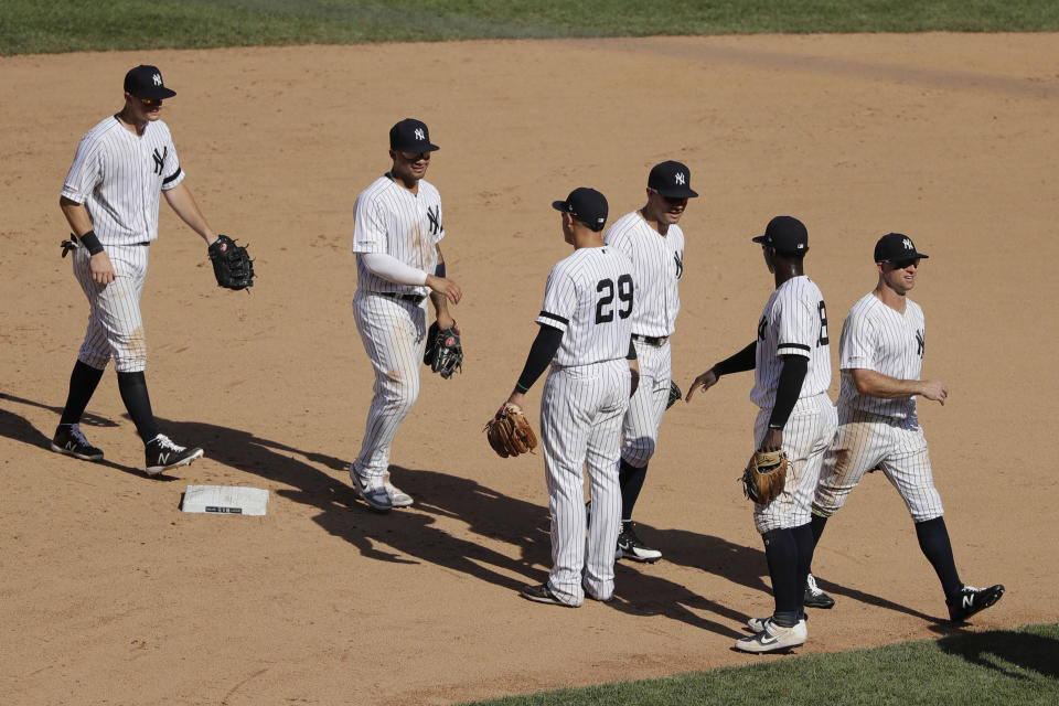 New York Yankees' Gio Urshela (29) and Didi Gregorius (18) celebrate with teammates after a baseball game against the Colorado Rockies Saturday, July 20, 2019, in New York. The Yankees won 11-5. (AP Photo/Frank Franklin II)