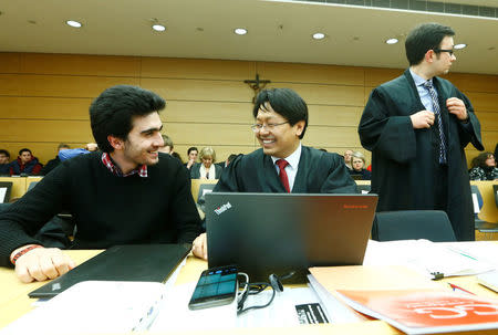 FILE PHOTO: Syrian refugee Anas Modamani accompanied by his lawyer Chan-Jo Jun attends a court session against Facebook over a selfie with Merkel at the district court in Wuerzburg, Germany February 6, 2017. REUTERS/Ralph Orlowski