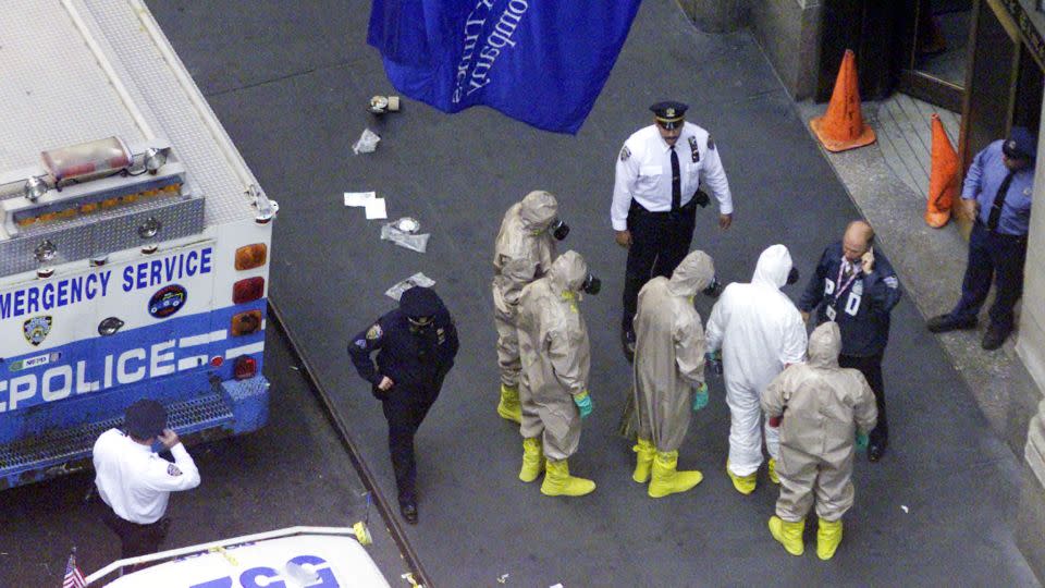 Investigators in protective suits prepare to enter the New York Times building in New York on October 12, 2001. - Peter Morgan/Reuters